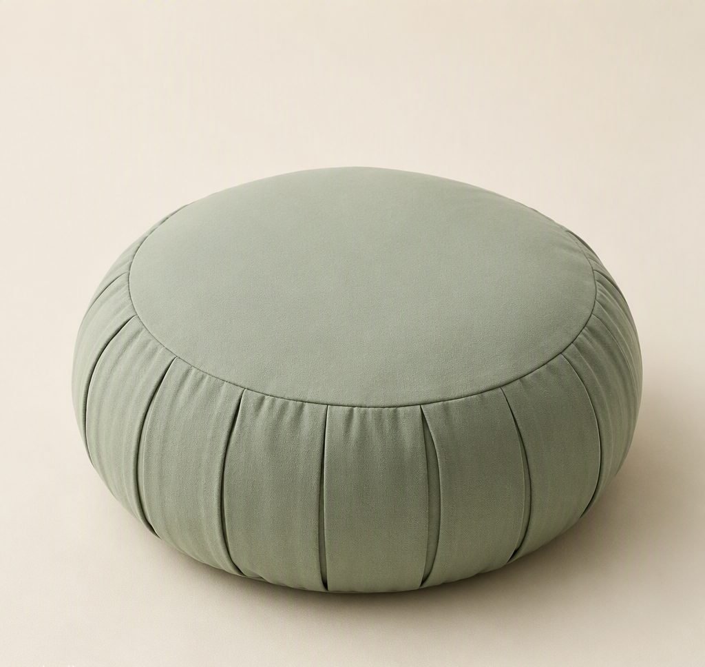 Round sage-green meditation cushion with pleated cotton cover